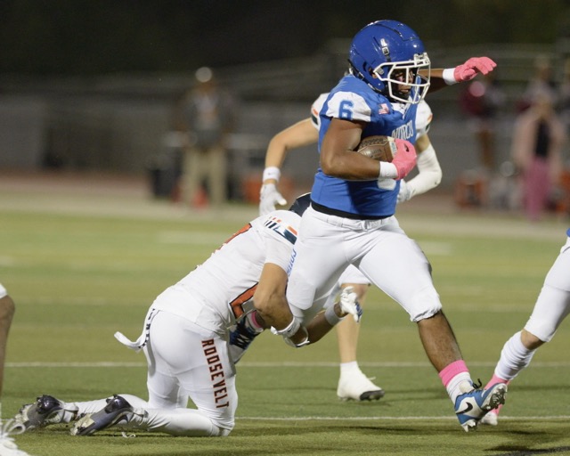 Norco running back Chris Laing tries to escape the grasp of a Roosevelt tackler.  
Credit: Photo by Jerry Soifer
