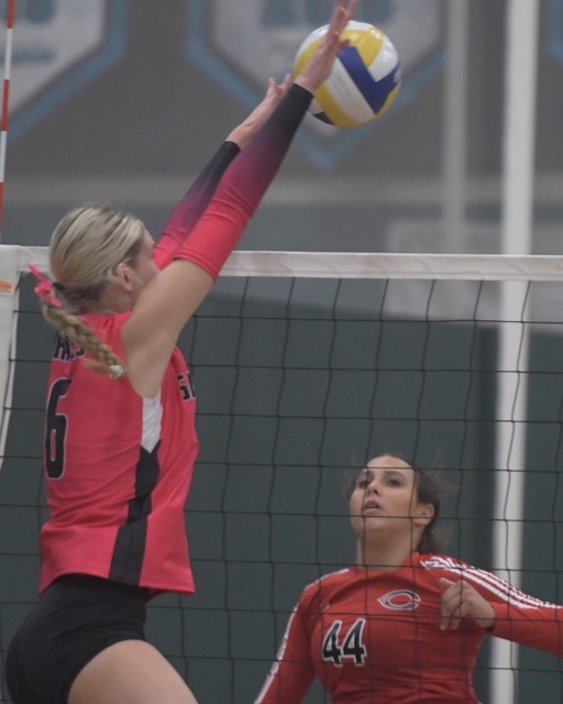 Corona Santiago’s Fallyn Blotzer tips the volleyball past Corona Centennial's Charlotte Mccully.  
Credit: Photo by Jerry Soifer
