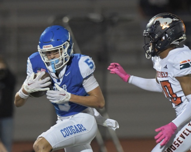 Norco's Blake Wong gains yardage after hauling-in a long pass to help the Cougars defeat visiting Roosevelt.
Credit: Photo by Jerry Soifer
