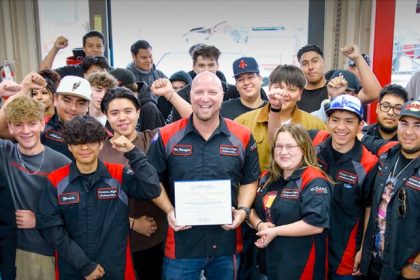 Corona High Automotive Technology Teacher Bob Mauger is surrounded by students celebrating their CA Teacher of the Year. Credit: Riverside County Office of Education