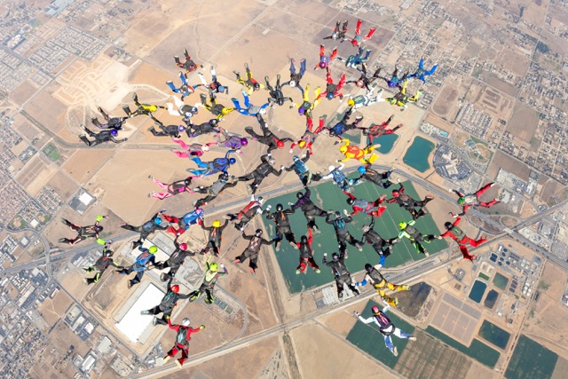 world record. 64 international women came together in unison to create the first snowflake formation. Credit: Photo by Bruno Brokken