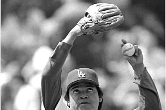 Fernando Valenzuela in 1986 exhibiting his famed windup, his arms, and eyes rolled up to the heavens, about to deliver his legendary screwball. Credit: Tony Barnard, Los Angeles Times via UCLA Archive