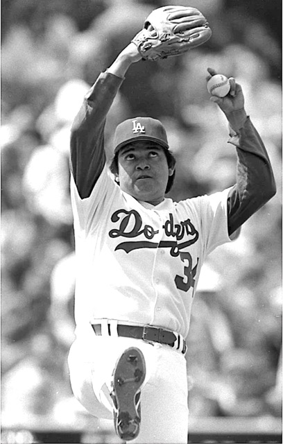 Fernando Valenzuela in 1986 exhibiting his famed windup, his arms, and eyes rolled up to the heavens, about to deliver his legendary screwball. Credit: Tony Barnard, Los Angeles Times via UCLA Archive