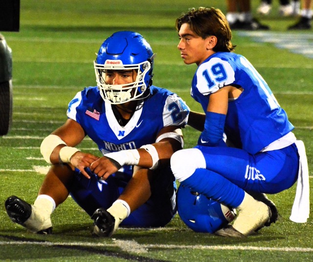 Norco senior football players Maddox Barrios (24) and Brady Wagner (19) console each other after their season-ending 20 – 16 loss to Vista Murrieta. Credit: Photo by Jerry Soifer