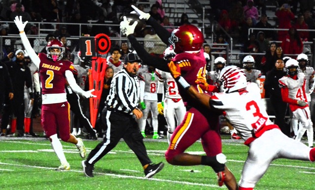 Riverside Hillcrest’s Julian Sandoval (2) starts to celebrate Nicholas Shaw’s (center) catch from a perfectly led pass by quarterback Alexander Villasenor while beating Valley View defensive back Tionne Billups (3). Shaw broke free and scored the first of two touchdown receptions on the night. The Trojans defeated the Eagles 24 – 14