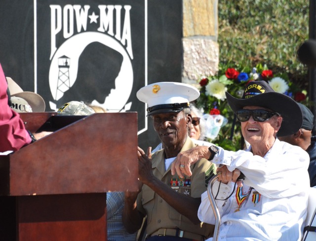 United States Marine Corps Gunnery Sergeant Ernest Nappier (left) and 89 year old Korean War Veteran Ken Morgan (right) listen to Norco Mayor Kevin Bash during the city’s annual Veterans Day observance at the George A. Ingalls Memorial plaza Monday morning. Photo by Gary Evans