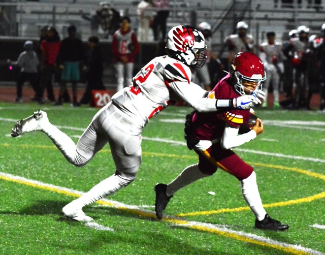 Riverside Hillcrest QB Alexander Villasenor (right) broke away from Valley View’s Elijah Buelna (22) despite being grabbed by his facemask. Hillcrest prevailed 24 – 14. Photo by Gary Evans