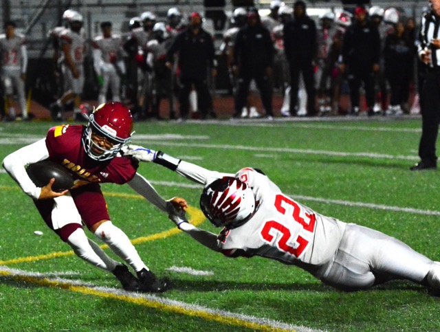 Riverside Hillcrest QB Alexander Villasenor (right) broke away from Valley View’s Elijah Buelna (22) despite being grabbed by his facemask. Hillcrest prevailed 24 – 14. Credit: Photo by Gary Evans