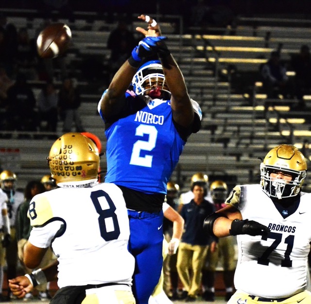 Vista Murrieta QB Ryland Duson’s pass is batted away by Norco defender Kameron Brown (2) while tackle Landon Thomas watches. Credit: Photo by Gary Evans