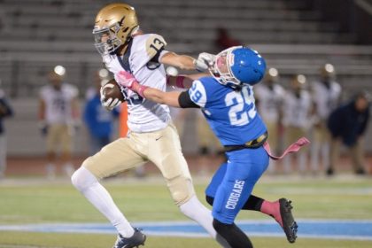 Vista Murrieta wide receiver Tyler Caldwell stiff arms Norco defensive back Joshua Cobain in a Big West Conference game. Credit: Photo by Jerry Soifer