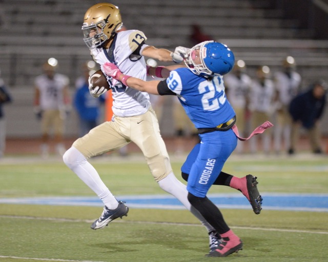 Vista Murrieta wide receiver Tyler Caldwell stiff arms Norco defensive back Joshua Cobain in a Big West Conference game. Credit: Photo by Jerry Soifer