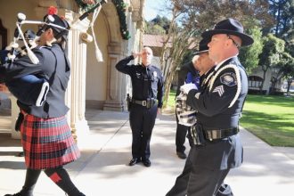 Roy VanderKallen. Corona Police Chief Robert Newman salutes as Officer Jason Waldron carries a flag and Sgt. Jesse Marquez bears an urn with the ashes of the late Corona Police Capt. Roy VanderKallen. Credit: Photo by Jerry Soifer