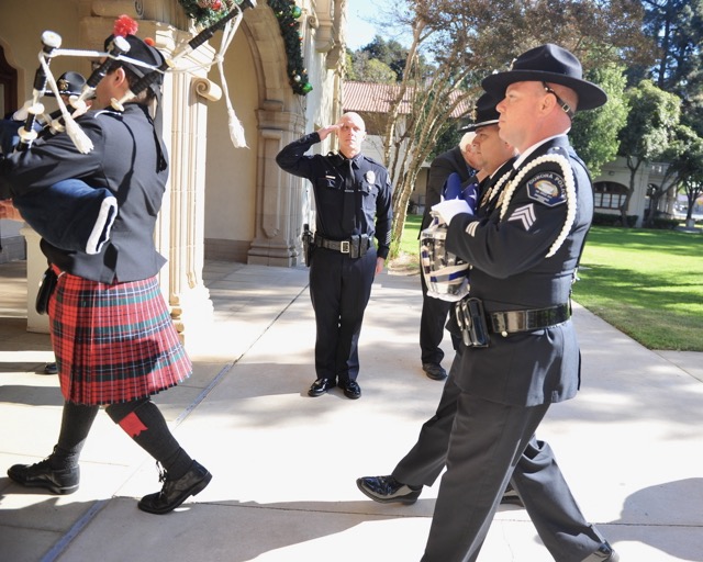 Roy VanderKallen. Corona Police Chief Robert Newman salutes as Officer Jason Waldron carries a flag and Sgt. Jesse Marquez bears an urn with the ashes of the late Corona Police Capt. Roy VanderKallen. Credit: Photo by Jerry Soifer