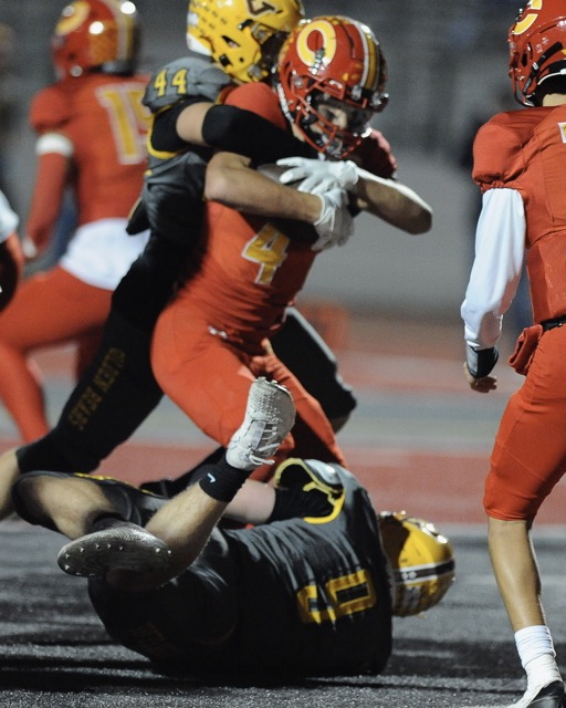 Corona running back Ryker Gazard is stopped for no gain Temecula Valley’s Vincent Evans in a Big West Conference game at Corona Friday. Temecula Valley won, 45-0. Credit: Photo by Gary Evans