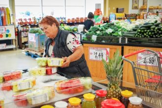 Caption: Mirna Hernandez shops at Superior Groceries in Victorville on Aug. 16, 2024. Minimum Wage. Credit: Photo by Ted Soqui for CalMatters