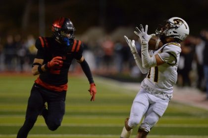 With Murrieta Valley’s Derrick Johnson Jr. in pursuit, Newbury Park's Alberto Ayon hauls in a long pass to set up a first-half touchdown, in the CIF Div. 2 championship game Saturday at Murrieta. Newbury Park won, 31-28 advancing to the South Section title game against San Diego Lincoln tonight at Southwestern College. Photo by Jerry Soifer