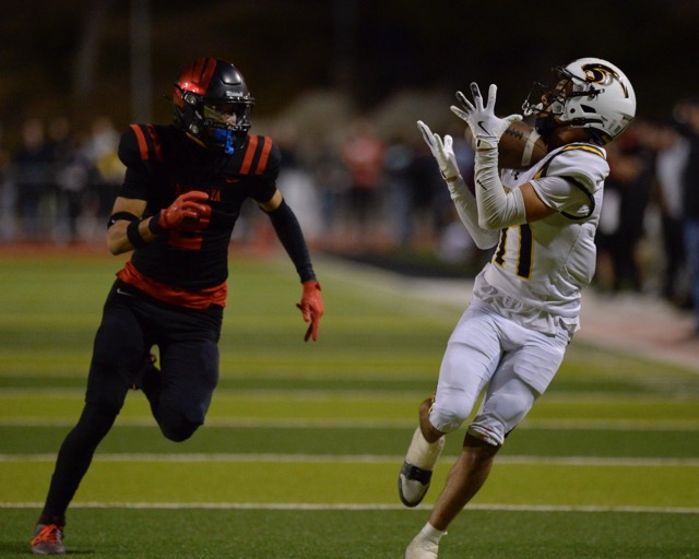 With Murrieta Valley’s Derrick Johnson Jr. in pursuit, Newbury Park's Alberto Ayon hauls in a long pass to set up a first-half touchdown, in the CIF Div. 2 championship game Saturday at Murrieta. Newbury Park won, 31-28 advancing to the South Section title game against San Diego Lincoln tonight at Southwestern College. Photo by Jerry Soifer