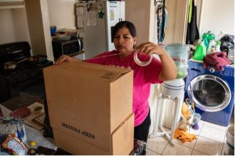 tenants. María Vela assembles a cardboard box as her family gets ready to move out of their home of nearly 30 years in East Los Angeles on Dec. 17, 2023.  Credit: Photo by Adriana Heldiz, CalMatters