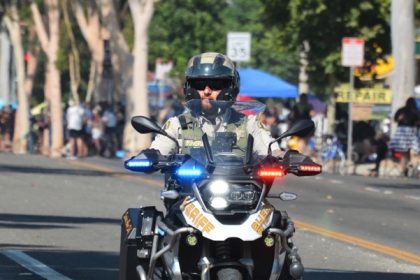 Caption: Riverside Sheriff Motor Deputy Timothy Corlew, seen here riding in the 2024 Norco Fair Labor Day Parade, was killed in an on-duty traffic accident on the 91 Freeway on January 8th.  Credit: Photo by Gary Evans