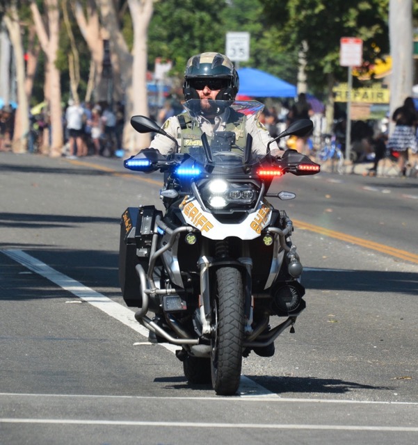 Caption: Riverside Sheriff Motor Deputy Timothy Corlew, seen here riding in the 2024 Norco Fair Labor Day Parade, was killed in an on-duty traffic accident on the 91 Freeway on January 8th.  Credit: Photo by Gary Evans