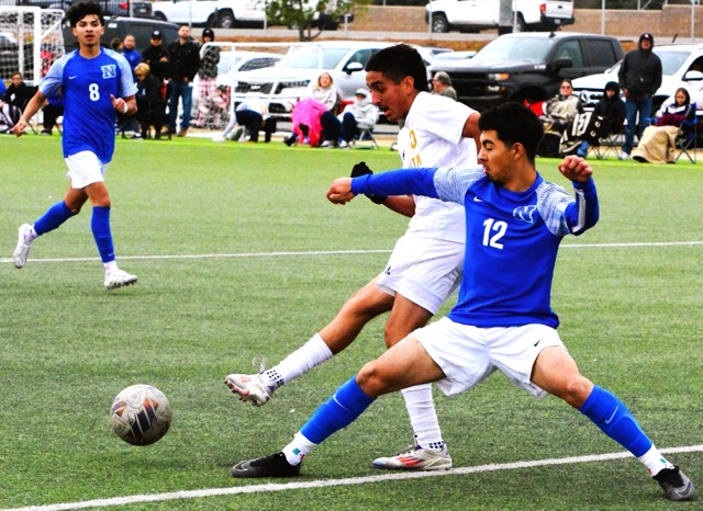 Norco’s Jeovani Mercado (12) battles Monte Vista’s Miguel Gomez (left) for the ball during the Cougars 1 – 1 tie with the Monarchs.  Norco’s Jesse Garcia (8) watches the play.
Credit: Photo by Gary Evans
