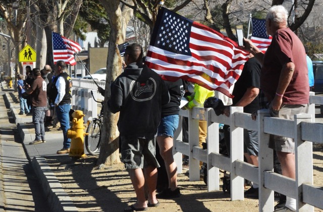 Norco residents paying their respect as the funeral procession of Deputy Timothy Corlew, passes by.