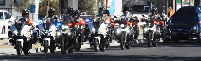 A Riverside County Sheriff Motorcycle Honor Guard leads the hearse  bearing escorting the remains of fallen motor Deputy Timothy Corlew.  Corlew died on Wednesday, January 8th when he struck a vehicle on the 91 Freeway near the La Sierra overpass on his way into Norco.  