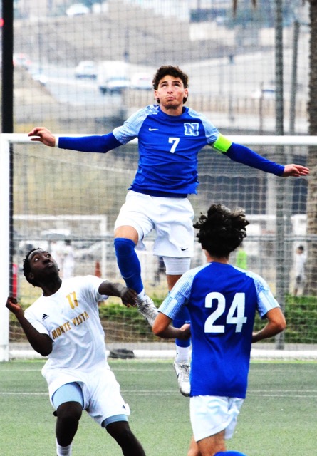 Monte Vista’s Prince Demunga (4) looks amazed at the height Norco’s Jaxon Killeen (7) reaches while looking heavenward for the ball. Nahum Palacious (24) watches the play. The Monarchs and the Cougars battled to a 1 – 1 tie during their first game in the Silver Lakes Tournament. Credit: Photo by Gary Evans