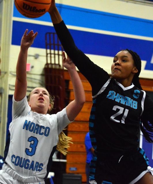 Norco’s Amber Mcclain (3) gets her layup blocked by Santiago’s Lyric Green (21).  The Sharks defeated the Cougars 65 – 15. 
Credit: Photo by Gary Evans
