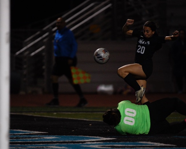 Corona Santiago's Kahlyn Brown leaps as she tries to score over Corona goalkeeper Brianna Cacao.