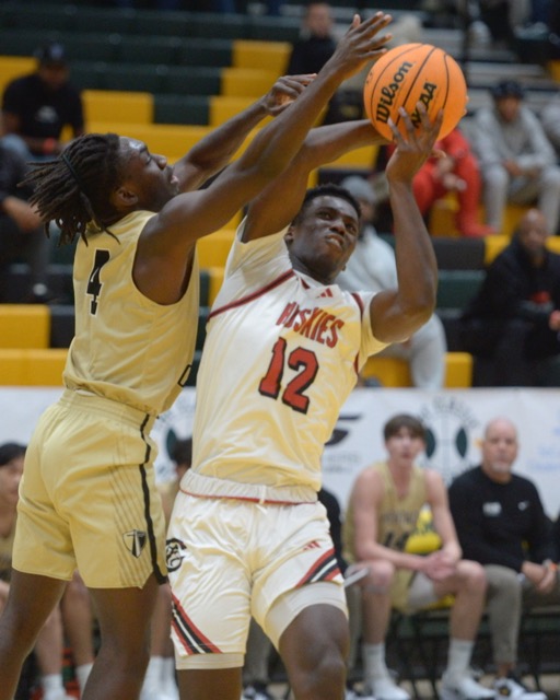 Northridge Heritage Christian's Jesse Tweneboah guards Corona Centennial's Tariq Iscandri during a first-round game at The Classic basketball tournament at Damien High in La Verne. Heritage Christan defeated the Huskies 77-65 Credit: Photo by Jerry Soifer