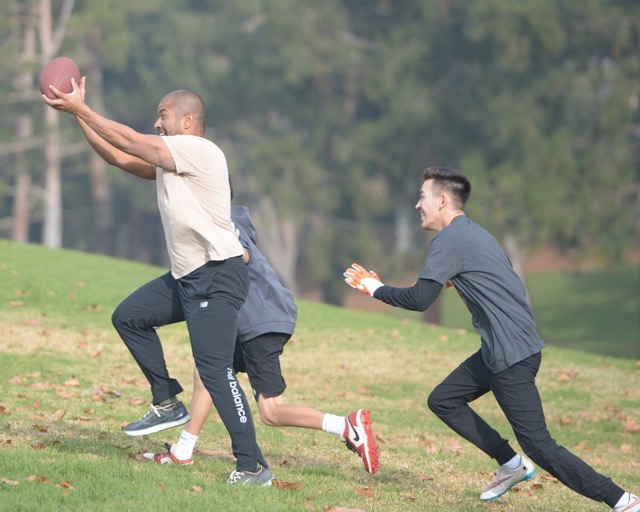 Mario Guzman snares an over-the-shoulder pass from Darrin Chiaverini against the defense of brothers Nathan and Nevin Lopez.