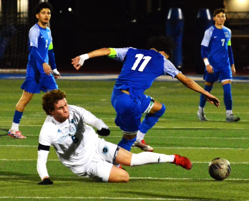 Corona Santiago’s Eric Schieferstein (6) slide tackles Norco’s Abraham Garcia (11) while Christopher Garcia (2) and Jaxon Killeen (7) watch in the background.  The Cougars defeated the Sharks 2 – 0 to close out the regular season. 