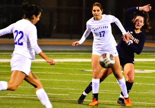 Westlake’s Tahirih Vahdat (22) kicks the ball downfield while teammate Calista Banihashemi (17) blocks Eastvale Roosevelt’s Emma Gause (right from the ball).  The Warriors knocked the Mustangs out of the CIF playoffs with a 2 – 0 victory.
Credit: Photo by Gary Evans
