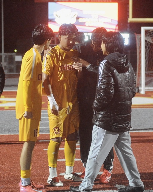 Corona boys’ soccer team members console each other after losing their Div. 1 playoff game with Villa Park, 2-1 in overtime last Thursday. The match was played in drenching rain.  
Credit: Photo by Jerry Soifer
