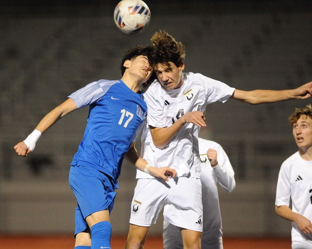 Caption: Calabasas’ Leo Vacca, (right), heads the ball against Norco's senior mid-fielder Bryan Vazquez in the second half of a CIF Div. 2 second-round playoff game won by the visiting Coyotes on penalty kicks. No goals were scored in 100 minutes of regulation and overtime. Photo by Jerry Soifer