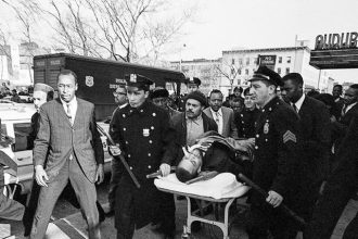 February 21. Malcolm X, on stretcher, is taken from the Audubon Ballroom after being shot Credit: United Press International