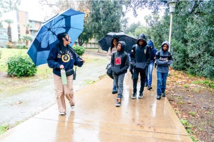 Keila Sakaguchi, a chemical engineering student at UC Riverside, gives students a tour of the campus on Feb. 13, 2025. The tour is part of an initiative to get middle school students and their families ready for the college application process in high school.  Credit: Photo by Kyle Grillot for CalMatters