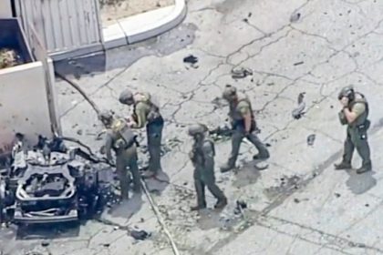 Palm Springs Bombing - Law enforcement investigate the 2010 silver Ford Fusion sedan that authorities say Guy Edward Bartkus ignited, killing himself and injuring four others last Saturday, May 17, in Palm Springs. Credit: ABC7 Los Angeles via AP