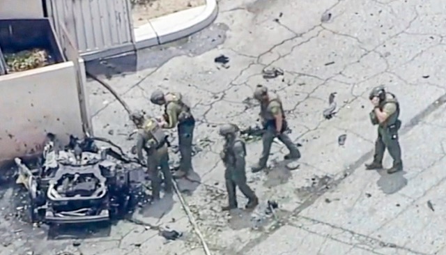 Palm Springs Bombing - Law enforcement investigate the 2010 silver Ford Fusion sedan that authorities say Guy Edward Bartkus ignited, killing himself and injuring four others last Saturday, May 17, in Palm Springs. Credit: ABC7 Los Angeles via AP