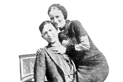 Bonnie Parker and Clyde Barrow, sometime between 1932 and 1934, when their exploits in Arkansas included murder, robbery, and kidnapping. Contrary to popular belief the two never married. They were in a longstanding relationship. Posing in front of a 1932 Ford V8 automobile. Recovered from Bonnie and Clyde after their deaths on May 23, 1934.