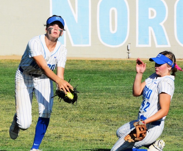 Norco centerfielder Dillyn Eckenrod Left) makes a running catch of a low line drive while right fielder Dakota Potter (right) slides in for backup during the Cougars’ 6 – 3 victory over Riverside King.