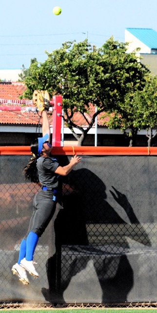 Norco left fielder Tamryn Shorter makes a valiant leap for a two run home run by Eastvale Roosevelt’s Loto Sivas during the 4th inning. The Mustangs handed the Cougars their first loss in the Big VIII league season 7 - 4.