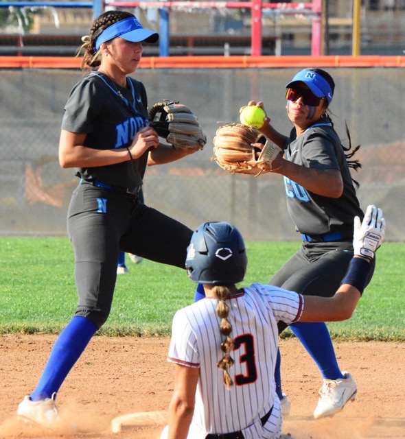 Norco shortstop Leighton Gray (left) took the ground ball, flipped to second baseman Sasha Pham (right) who forces out Roosevelt’s Aubrey McLaughlin (3) at second while trying for the double play. The Mustangs handed the Cougars their first league loss of the season, 7 – 4.
