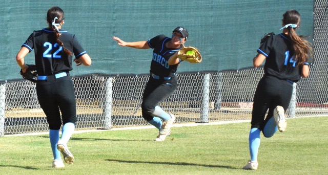 Norco left fielder Tamryn Shorter (center) snags a foul ball for an out while third baseman Sadie Burroughs (22) and shortstop Leighton Gray (14) pursue during the Cougars 6 – 1 CIF Division 1 semi-final victory over Chino Hills Ayala.  The Cougars play Orange El Modena for the championship at Deanna Manning Stadium in Irvine, California, on Saturday at 7 pm.