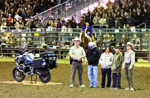 The City of Norco gave tribute to late Riverside County Sheriff Motor Deputy Timothy Corlew Saturday night at the Norco Rodeo.  Corlew died in a collision on the 91 Freeway in Riverside while on his way to work in Norco the morning of January 8th, 2025.  Norco based Deputies and other motor deputies joined Corlew’s wife and sons in the arena while Norco women carried the thin Blue Line flags on horseback.   Corlew’s BMW GS patrol bike was presented center stage in tribute to the fallen Deputy. 
Credit: Photo by Gary Evans
