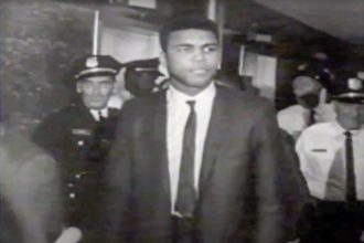 June 20 . Photo: AliCourtHouse Caption: Muhammad Ali Leaves the Courtroom in Houston, TX after being sentenced to 5 years in prison for evading the draft during the Vietnam War.
