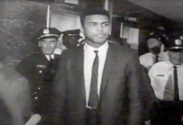 June 20 . Photo: AliCourtHouse Caption: Muhammad Ali Leaves the Courtroom in Houston, TX after being sentenced to 5 years in prison for evading the draft during the Vietnam War.