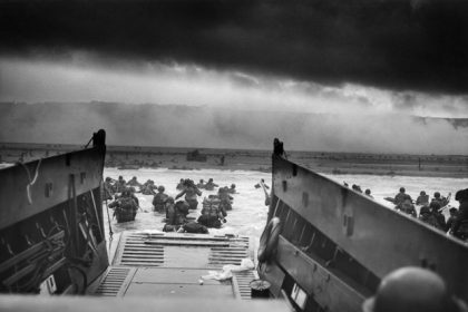 A LCVP (Landing Craft, Vehicle, Personnel) from the U.S. Coast Guard-manned USS Samuel Chase disembarks troops of Company A, 16th Infantry, 1st Infantry Division (the Big Red One) wading onto the Fox Green section of Omaha Beach (Calvados, Basse-Normandie, France) on the morning of June 6, 1944. American soldiers encountered the newly formed German 352nd Division when landing. During the initial landing two-thirds of Company E became casualties. Credit: Chief Photographer's Mate (CPHoM) Robert F. Sargent