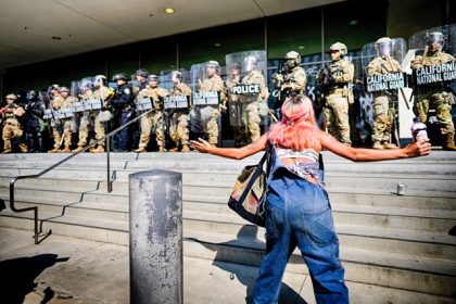 Maximalist Immigration Campaign. A protester engages a line of California National Guard protecting a federal building in downtown Los Angeles on Monday, June 9, 2025.  Credit: AP Photo/Eric Thayer